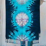 Tie-dyed blue and white scarf with tasseled fringe, a stylish clothing accessory