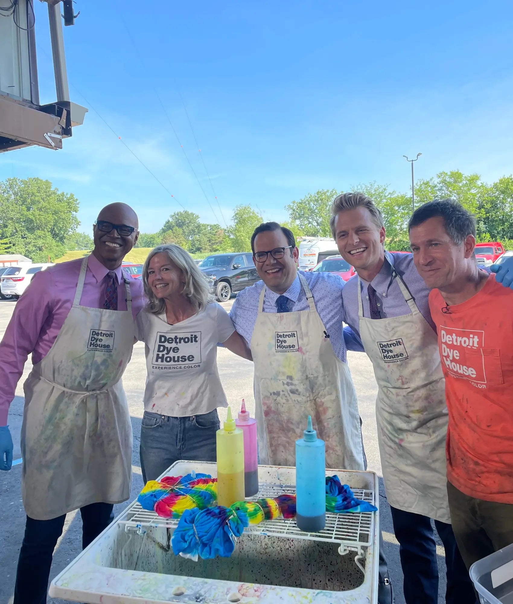 Group in aprons at a snow cone station during Detroit Dye House event.