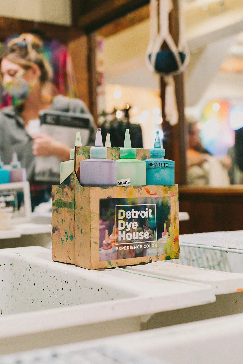 Cardboard drink carrier from Detroit Dye House filled with colorful dye bottles for a dye class