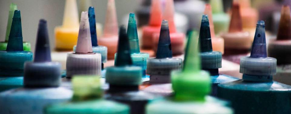 Colorful paint bottles with pointed nozzle tips for Corktown Dye classes collection.