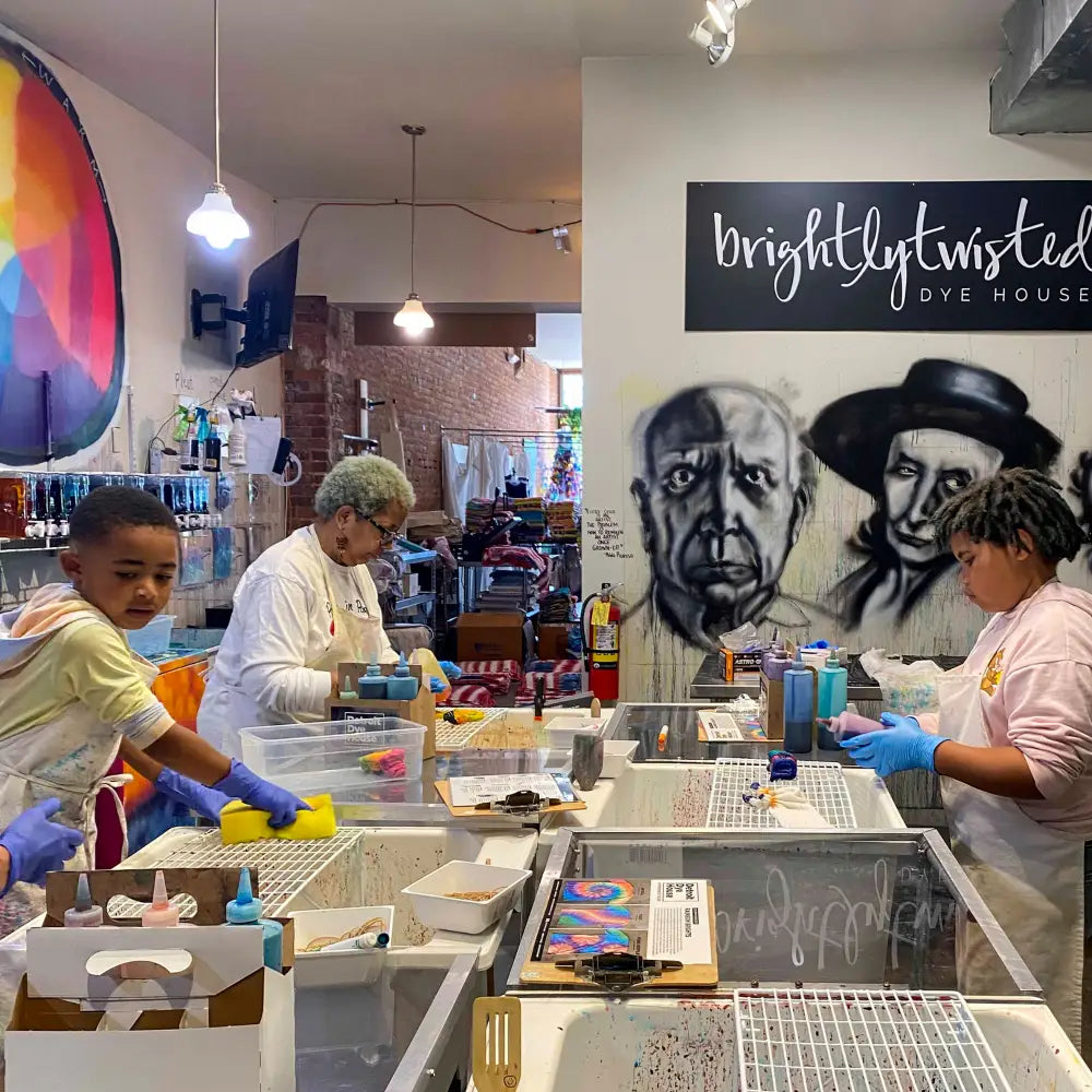 People preparing meals at a food service counter in a Detroit dye house