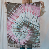 Tie-dyed fabric throw scarf with pink, blue, and brown spiral pattern and fringe