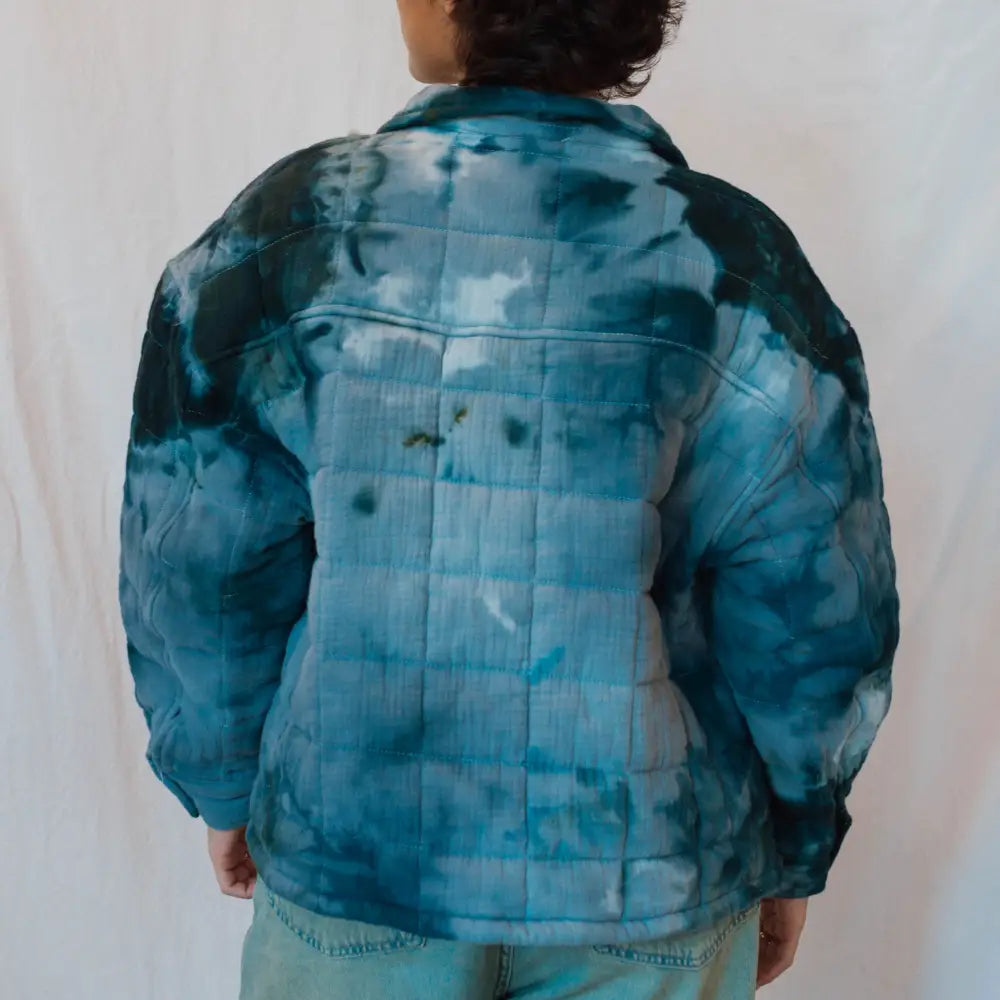 Back view of Angie Jacket, a tie-dyed blue puffy winter jacket for stylish warmth