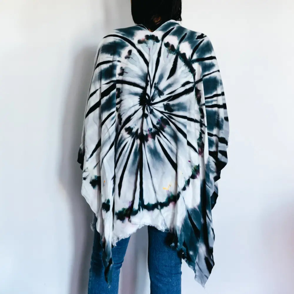 Black and white tie dye poncho wrap featuring a spiral pattern for stylish clothing