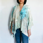 Flowy tie-dye kimono wrap in turquoise and white, styled with blue jeans