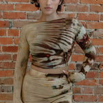 Cait Set features a tie-dyed beige crop top and abstract brown patterns maxi skirt