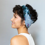 Brightlytwisted headband in blue and white tie-dyed silk with dark hair updo