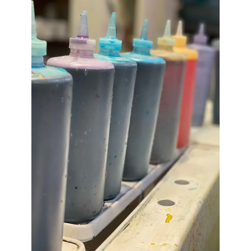 Row of colorful ink cartridges for tie dye projects in the Birthday Party Package - CORKTOWN