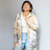 Kyle jacket with tie-dyed beige and gray hoodie, light jeans, and white tank top