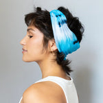 Brightlytwisted headband features a bright blue and white tie-dyed design as a hair accessory