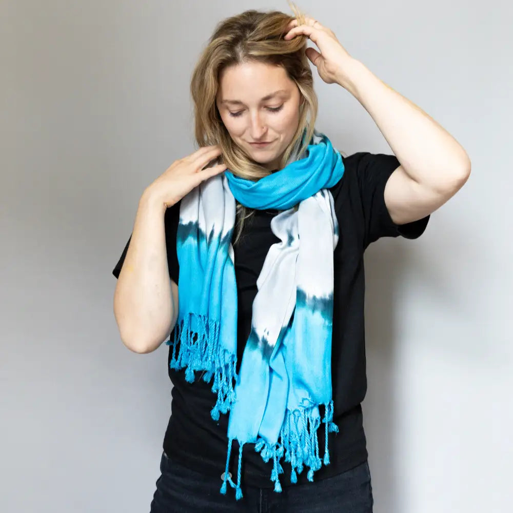 Bright turquoise and white tie dye scarf with tassels from Lions Bundle clothing