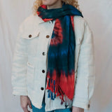 White denim jacket with a red and teal tie dye scarf for stylish clothing