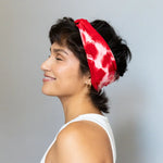 Red and white tie-dyed BrightlyTwisted headband features a retro style