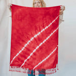 Red tie-dyed scarf with diagonal white stripes and fringe for stylish clothing