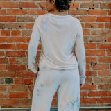 White So Soft Serena Top worn backwards with paint stains for a trendy look