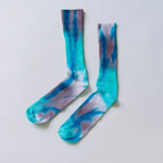 Pair of tie-dyed bamboo rayon socks in turquoise and purple colors