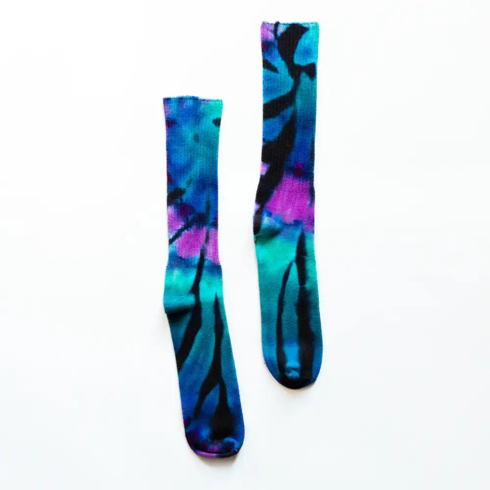 Tie dye bamboo rayon socks featuring blue, turquoise, purple, and black patterns