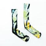 Tie-dyed bamboo rayon socks in black, yellow, and mint green swirling patterns