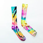 Colorful tie dye socks in pink, yellow, blue, and black made from bamboo rayon