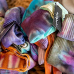 Colorful soft socks in vibrant purple, orange, and turquoise from Dyer’s Choice Sock Special