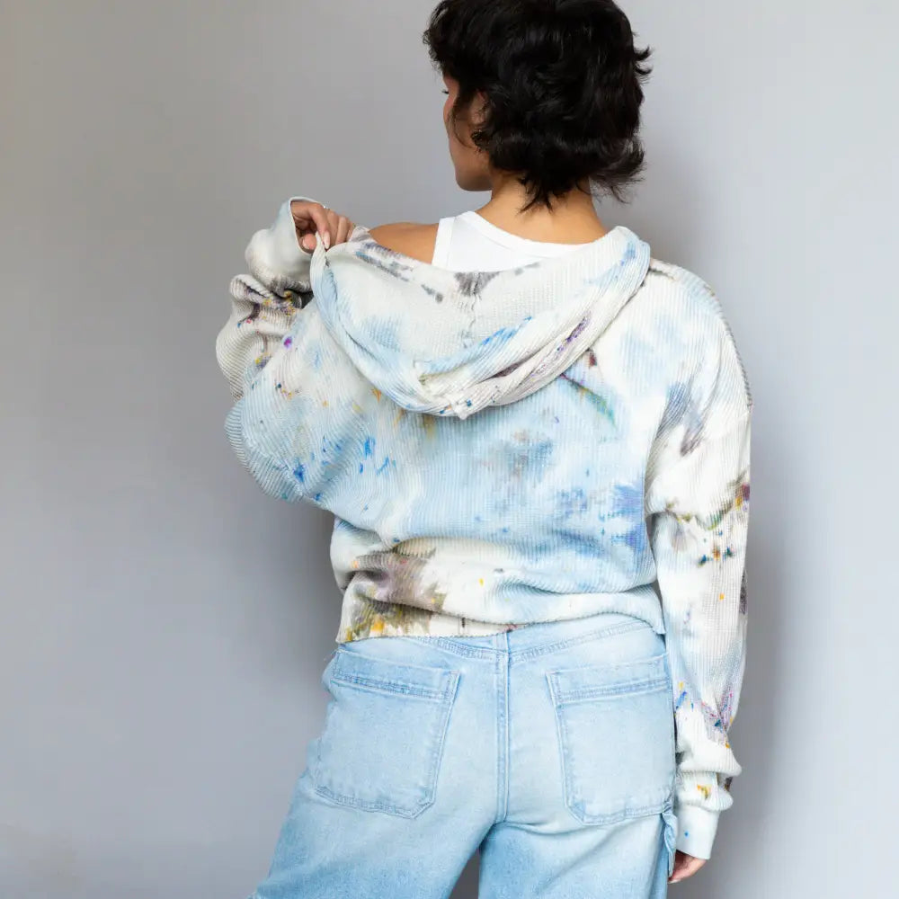 Sophie Pullover tie-dyed blue and white hoodie paired with light denim shorts