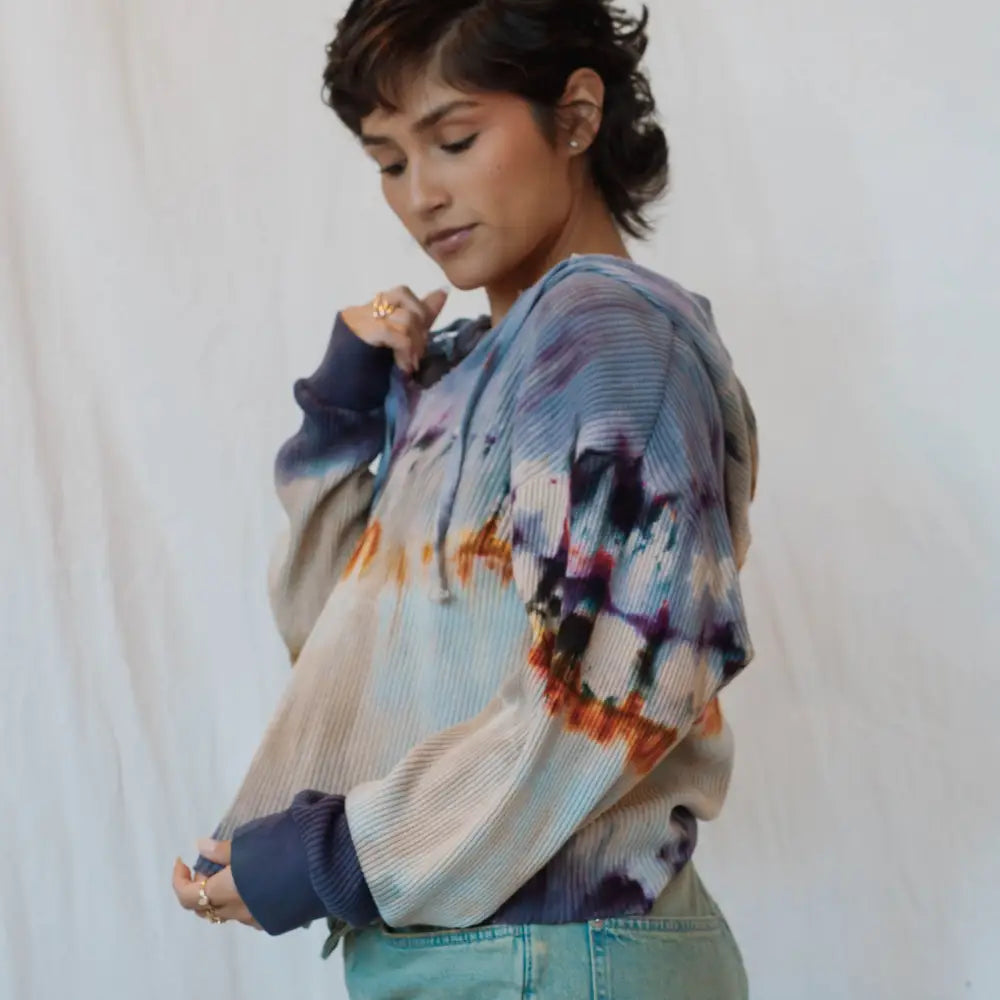 Tie-dyed Sophie pullover with blue, orange, and purple watercolor patterns in waffle knit