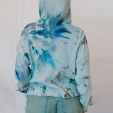 Tie-dyed blue and white Sophie pullover worn backwards with waffle knit texture