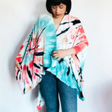 Tie dye kimono-style wrap in turquoise, coral pink, and black patterns for stylish clothing