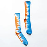 Tie dye bamboo rayon socks featuring blue and orange zigzag patterns