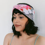 Floral watercolor BrightlyTwisted headband with pink and gray tones worn in dark hair