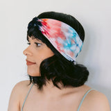 BrightlyTwisted headband with red and blue watercolor tie-dyed patterns