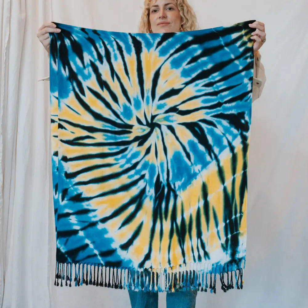 Tie-dyed blue and yellow spiral scarf with tasseled fringe for vibrant clothing style