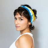 BrightlyTwisted headband features colorful stripes in blue, white, and yellow for dark hair