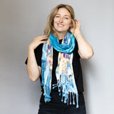 Vibrant blue tie dye scarf with fringe tassels and floral patterns for stylish clothing