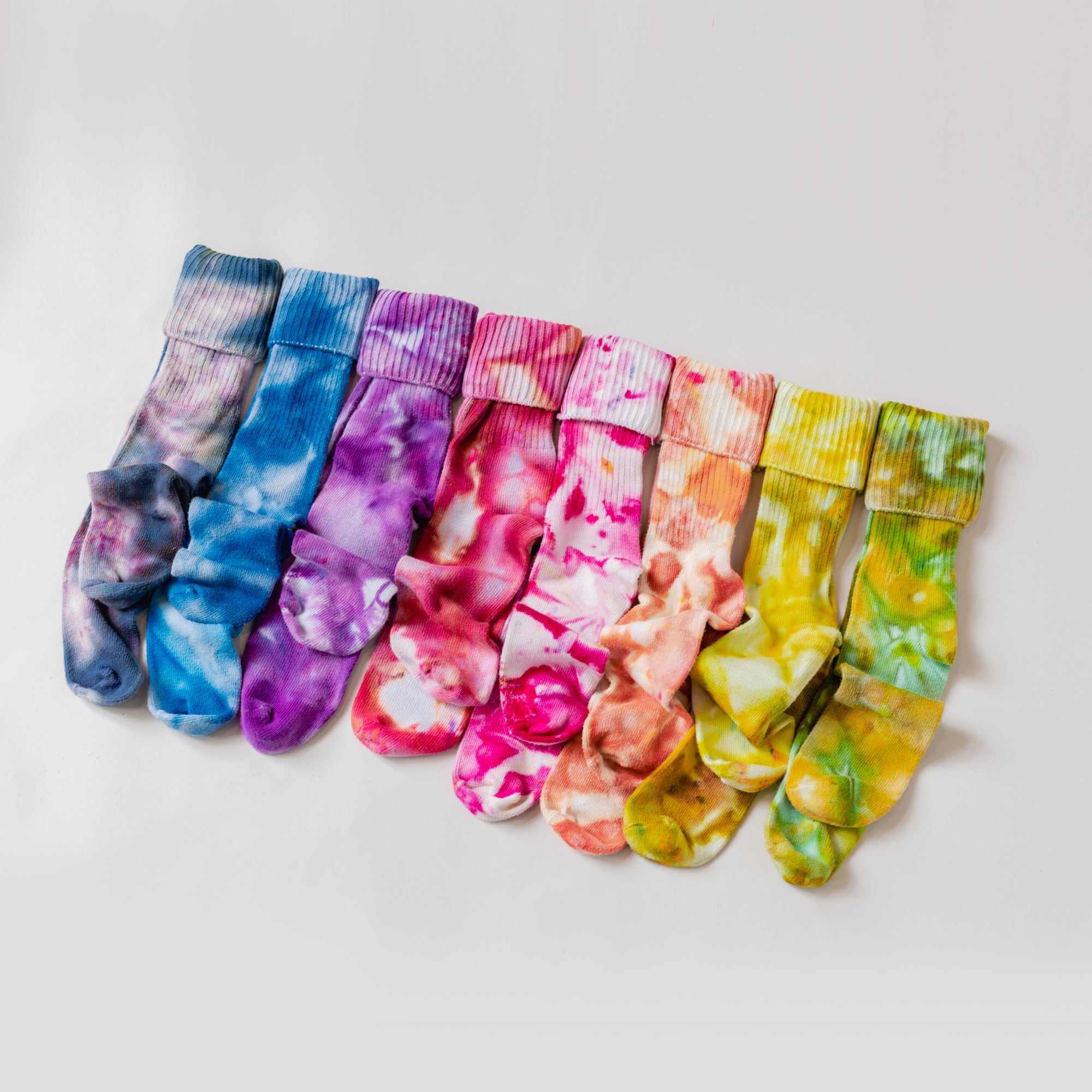 A rainbow of color socks laid out.