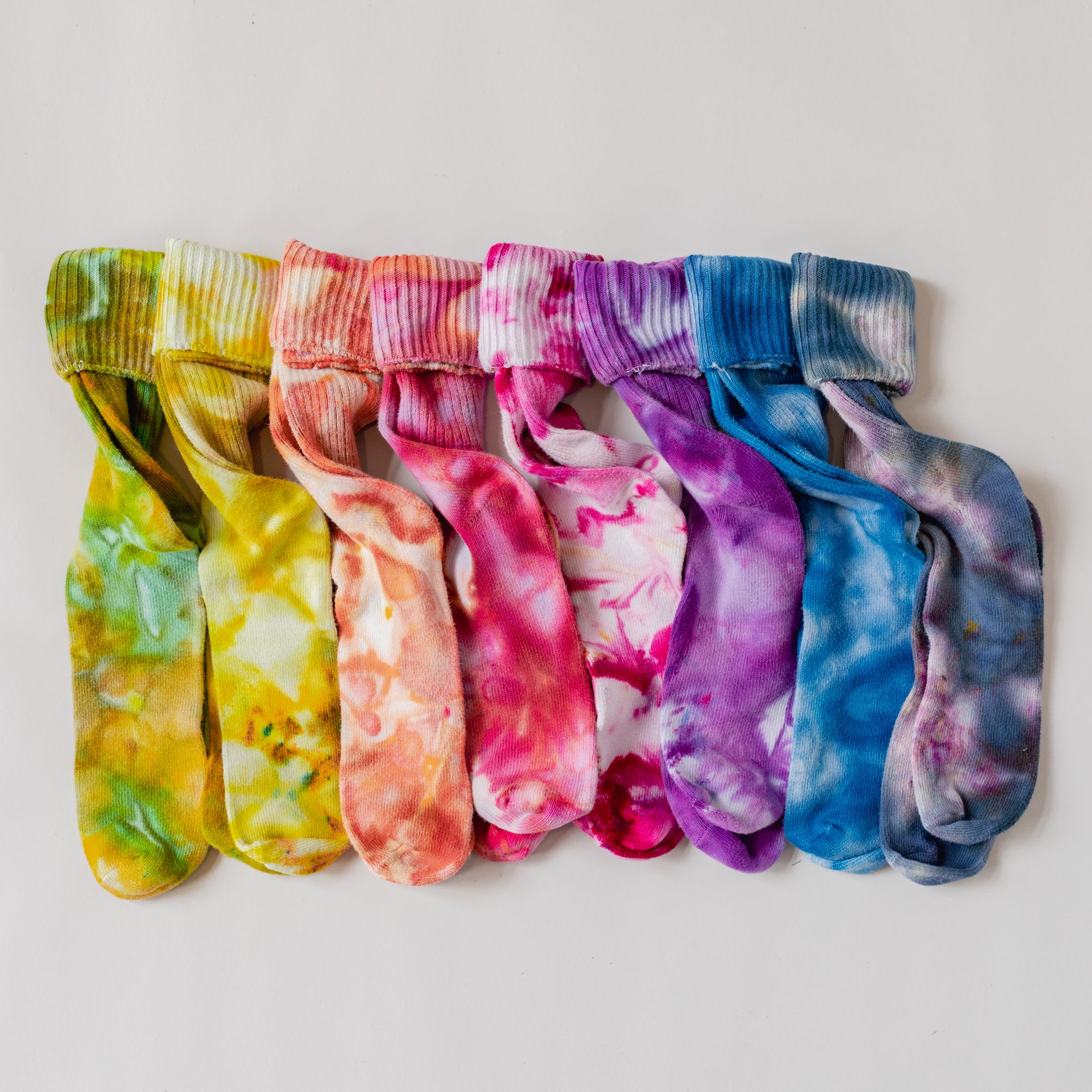 A rainbow of color socks laid out.