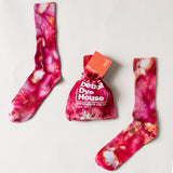 Color socks in varying shades of red with a matching bag.