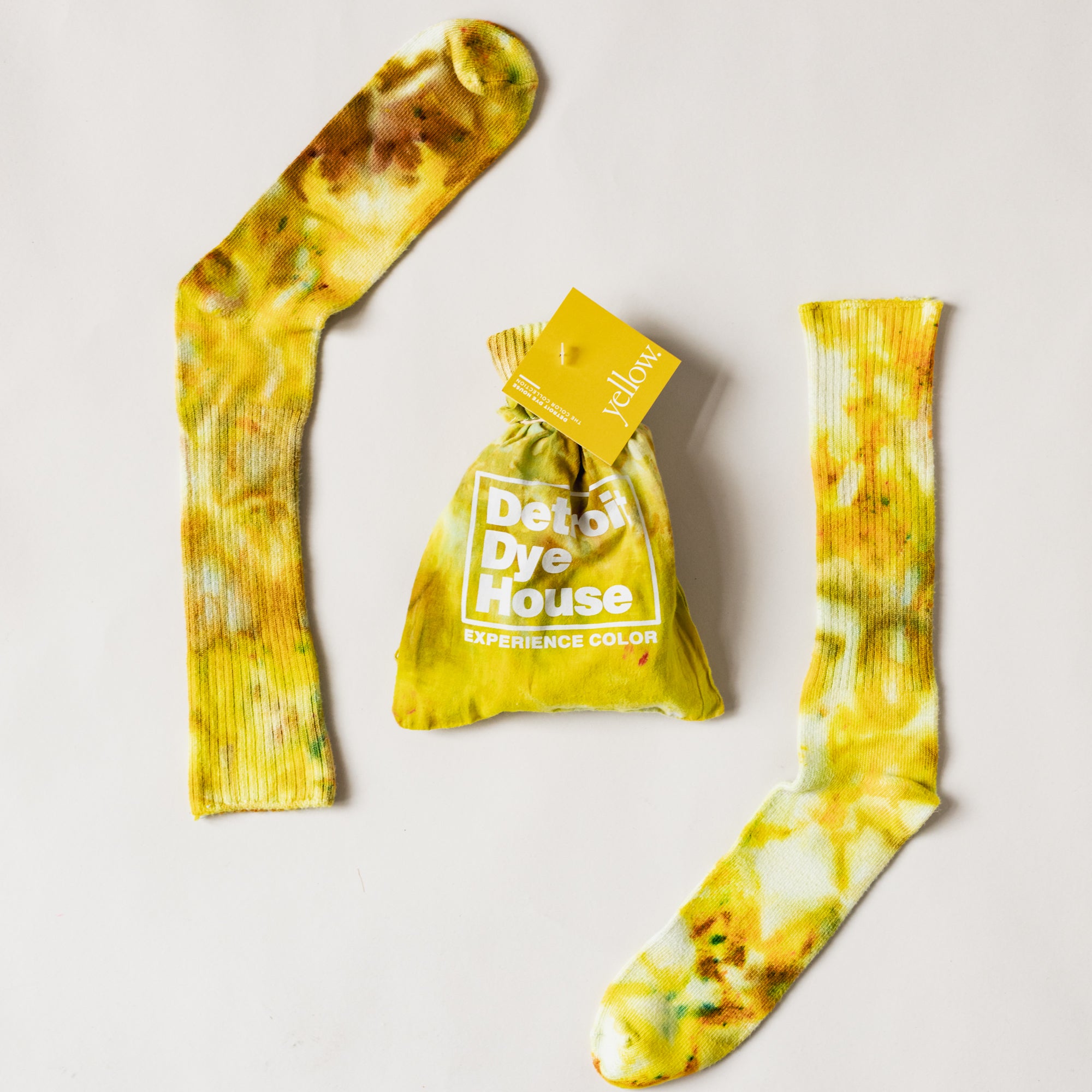 Color socks in varying yellows with a matching bag.