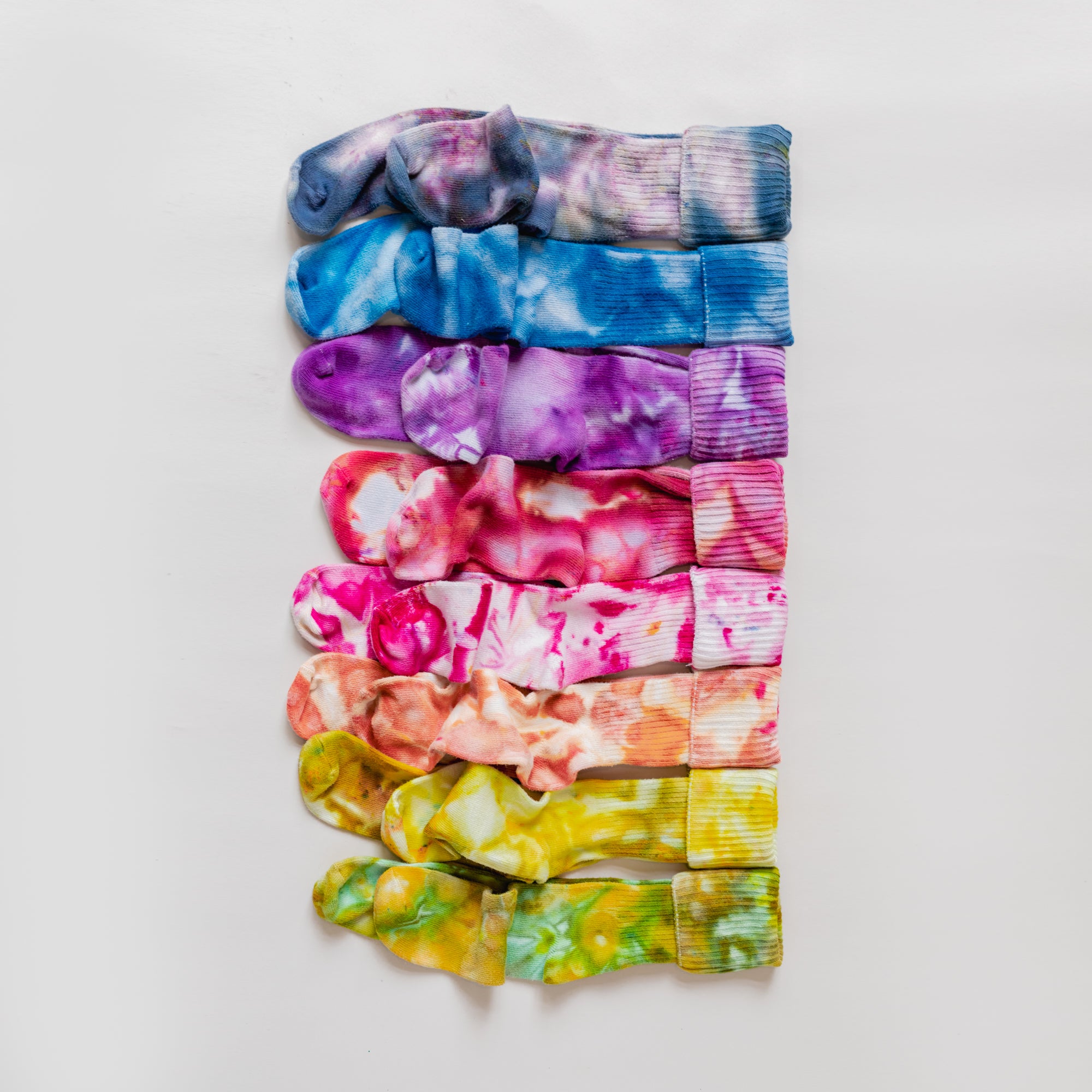 A rainbow of color socks laid out.