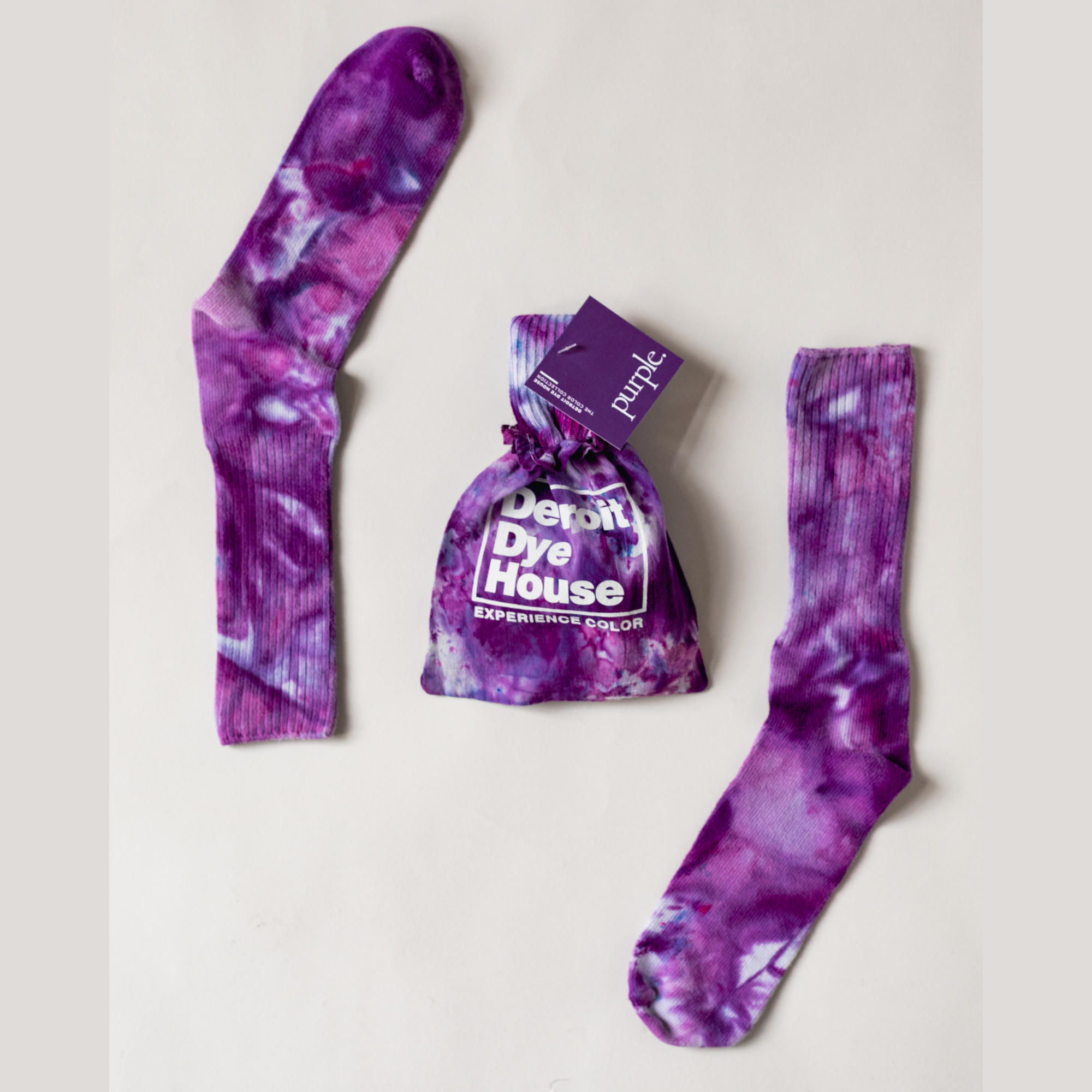 Color socks in varying purples with a matching bag.
